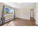Well-lit bedroom with hardwood floors and a large window overlooking the neighborhood at 6895 E 74Th Ave, Commerce City, CO 80022