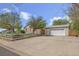 Charming home featuring a spacious driveway leading to a detached garage and well-maintained landscaping at 6895 E 74Th Ave, Commerce City, CO 80022