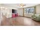 Inviting living room with wood floors, a ceiling fan, and abundant natural light at 6895 E 74Th Ave, Commerce City, CO 80022