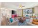 Bright living room featuring hardwood floors, large window, and comfortable seating area at 6895 E 74Th Ave, Commerce City, CO 80022