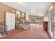 Spacious enclosed patio with brick accents and ample natural light from surrounding windows at 6895 E 74Th Ave, Commerce City, CO 80022