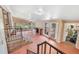 Large covered patio with access to the backyard, fireplace, and stairs to the basement at 6895 E 74Th Ave, Commerce City, CO 80022