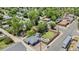 Aerial view of the property featuring a large backyard, patio, and surrounding neighborhood at 1390 Emporia St, Aurora, CO 80010