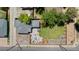 Aerial shot of a home with a well-manicured lawn, patio with seating, and a bocce ball court at 1390 Emporia St, Aurora, CO 80010