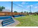 Backyard with raised garden beds, a lawn, and patio area, surrounded by a wood fence at 1390 Emporia St, Aurora, CO 80010
