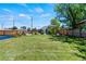 Spacious backyard with lush lawn, fenced perimeter, and outdoor seating area at 1390 Emporia St, Aurora, CO 80010
