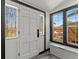 Bright foyer featuring a white front door with decorative glass and a window view to the back yard at 1390 Emporia St, Aurora, CO 80010