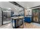 Stylish kitchen featuring a center island with seating, stainless steel appliances, and blue accents at 1390 Emporia St, Aurora, CO 80010