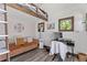 Living area features a seating area and wooden desk with ladder to loft area at 1390 Emporia St, Aurora, CO 80010