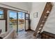 Living area features sliding glass door, view to the outside, and ladder to a loft area at 1390 Emporia St, Aurora, CO 80010