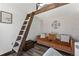 Living area features a brown couch and wooden ladder to a loft area at 1390 Emporia St, Aurora, CO 80010