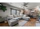 Comfortable living room with a large sectional sofa, wood accent wall, and natural light at 1390 Emporia St, Aurora, CO 80010