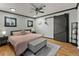 Spacious main bedroom with hardwood floors, ceiling fan, and a sliding barn door at 1390 Emporia St, Aurora, CO 80010