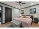 Cozy bedroom with large windows, ceiling fan, and hardwood floors at 1390 Emporia St, Aurora, CO 80010