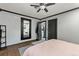 Spacious main bedroom featuring mirror, ceiling fan, and hardwood floors at 1390 Emporia St, Aurora, CO 80010
