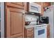 Kitchen with oak cabinets, microwave, and stove top at 79 N 13Th Ave, Brighton, CO 80601