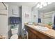 Well-lit bathroom with a mosaic tile accents, updated fixtures, large vanity and decorative wall art at 12931 E 46Th Ave, Denver, CO 80239