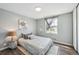 Bright bedroom with natural light, plank flooring, decorative artwork and a cozy bed at 12931 E 46Th Ave, Denver, CO 80239