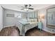Cozy bedroom featuring modern decor, stylish furnishings, wood floors, and a ceiling fan for added comfort at 12931 E 46Th Ave, Denver, CO 80239