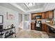 Open concept kitchen with wood cabinetry, modern appliances, and convenient access to the stairs and other living areas at 12931 E 46Th Ave, Denver, CO 80239