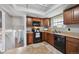 Modern kitchen featuring wood cabinets, black appliances, and a stylish design, creating a functional cooking space at 12931 E 46Th Ave, Denver, CO 80239