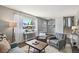 Inviting living room with large window, modern furnishings, and neutral decor creating a comfortable and bright space at 12931 E 46Th Ave, Denver, CO 80239