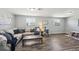 Cozy living room features lots of natural light, luxury vinyl plank floors, and stylish decor at 12931 E 46Th Ave, Denver, CO 80239