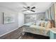 Comfortable bedroom with a light color palette, a ceiling fan, modern decor and a comfortable king size bed at 12931 E 46Th Ave, Denver, CO 80239
