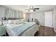 A cozy primary bedroom with a ceiling fan, calming color palette and a comfortable king size bed at 12931 E 46Th Ave, Denver, CO 80239