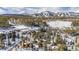 Winter aerial scene featuring several homes surrounded by snow-covered trees, with a mountain backdrop at 876 Broken Lance Dr, Breckenridge, CO 80424