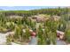 Aerial shot of a mountain community surrounded by green trees with a paved parking lot at 876 Broken Lance Dr, Breckenridge, CO 80424