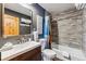 Bathroom featuring a shower and tub, with wooden accents at 876 Broken Lance Dr, Breckenridge, CO 80424