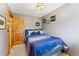 Comfortable bedroom with a blue patterned comforter, neutral walls, and a natural wood door at 876 Broken Lance Dr, Breckenridge, CO 80424