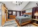 Bedroom with a wooden bed frame, skylight, dresser, and purple curtains at 876 Broken Lance Dr, Breckenridge, CO 80424