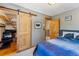 Bedroom with sliding closet doors, neutral walls, and an open wood door at 876 Broken Lance Dr, Breckenridge, CO 80424