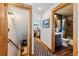 Hallway view featuring a bathroom, kitchen, stairs to the basement, and a decorative rug at 876 Broken Lance Dr, Breckenridge, CO 80424
