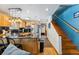 Open kitchen featuring stainless steel appliances, wooden cabinets, a breakfast bar, and wooden stairs at 876 Broken Lance Dr, Breckenridge, CO 80424