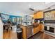 Open-concept kitchen with an island, stainless steel appliances, and access to the living area at 876 Broken Lance Dr, Breckenridge, CO 80424