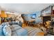Open-concept living area with a fireplace, dining space, and a comfortable sofa at 876 Broken Lance Dr, Breckenridge, CO 80424