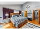 This main bedroom features a wooden frame, black and white bedding, hardwood floors, and an elegant chandelier at 876 Broken Lance Dr, Breckenridge, CO 80424