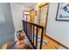 Wooden staircase overlooking a dining area with wood floors and railing at 876 Broken Lance Dr, Breckenridge, CO 80424