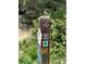 Close up of trail marker, with hiking and biking symbols, promotes outdoor activities at 876 Broken Lance Dr, Breckenridge, CO 80424