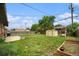 Spacious backyard featuring a well-maintained lawn, storage shed, swing set, raised garden beds, and partially fenced yard at 7625 Turner Dr, Denver, CO 80221