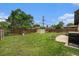 Spacious backyard featuring a well-maintained lawn, storage shed, swing set, fire pit, and partially fenced yard at 7625 Turner Dr, Denver, CO 80221