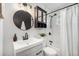 Stylish bathroom featuring a sleek vanity with modern fixtures and a subway-tiled shower with black hardware at 7625 Turner Dr, Denver, CO 80221