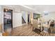 Open floor plan showcasing a dining area adjacent to a staircase with contemporary decor and ample natural light at 7625 Turner Dr, Denver, CO 80221