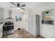 Bright kitchen featuring modern appliances, sleek cabinets, and eat-in dining area at 7625 Turner Dr, Denver, CO 80221