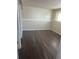 Finished basement room with dark laminate flooring at 4316 N Malta St, Denver, CO 80249