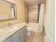 Updated bathroom with granite vanity and tiled shower/tub at 4316 N Malta St, Denver, CO 80249