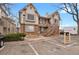 Charming two-story condo featuring a brick facade, wooden stairs, balcony and dedicated parking space at 195 S Sable Blvd # U12, Aurora, CO 80012
